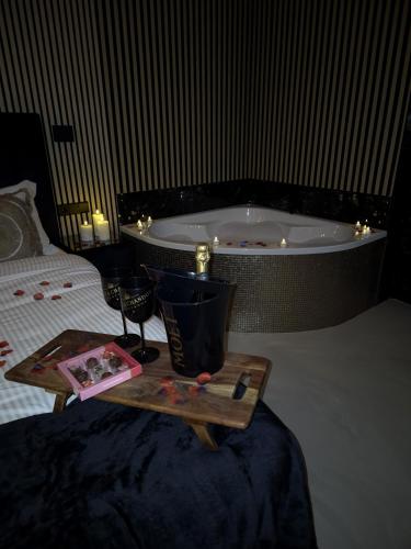 a bed with a tray with a candle and a bath tub at Hotel Broer & Zus in The Hague