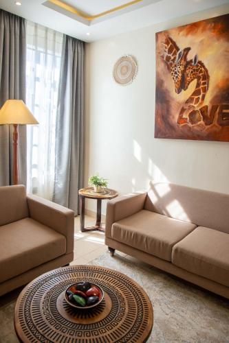 a living room with a couch and a table at Gigiri Lion Villas I in Nairobi