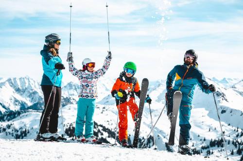 a group of four people standing on top of a mountain at KitzAlps Apartments by Alpine Host Helpers in Kirchberg in Tirol
