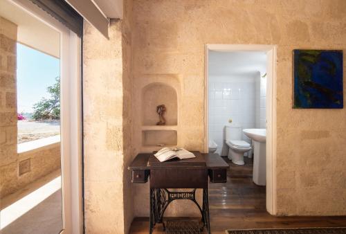 a bathroom with a table with a book on it at Artisan Villa Aegina in Aegina Town