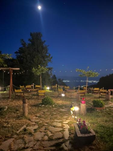 a night view of a park with benches and the moon at Tasia Mountain Hotel in Chania