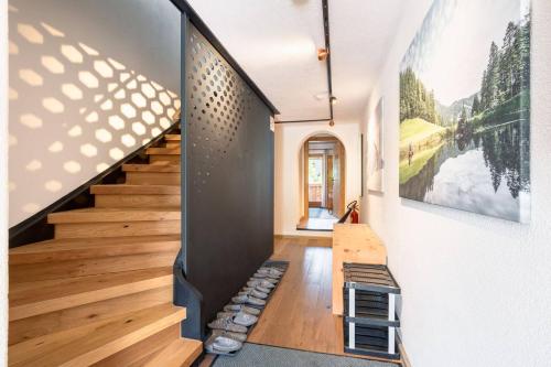 a staircase in a home with a bench and a painting at Grand Chalet Hochfilzen in Hochfilzen