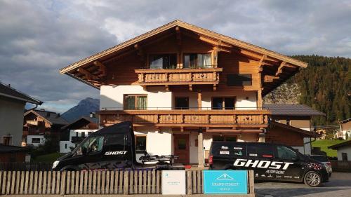 a wooden house with a balcony on top of it at Grand Chalet Hochfilzen in Hochfilzen