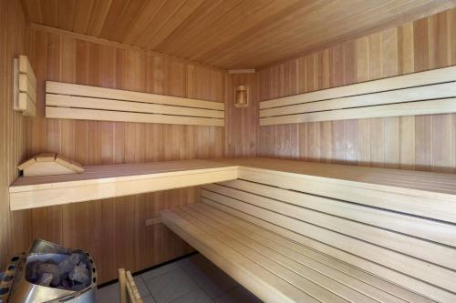 a small sauna with wooden walls and wooden shelves at Grand Chalet Hochfilzen in Hochfilzen