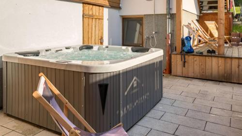 a hot tub in the backyard of a house at Grand Chalet Hochfilzen in Hochfilzen