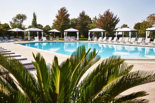 a large swimming pool with chairs and umbrellas at San Clemente Palace Venice in Venice