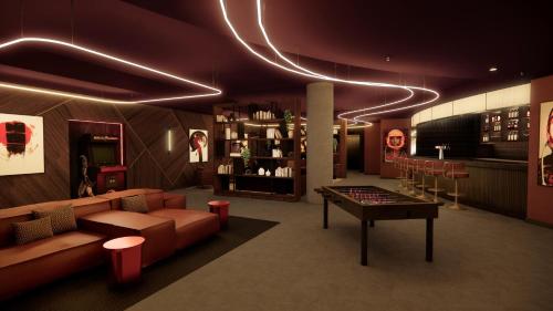 a room with a couch and a table and a bar at Radisson RED London Twickenham in Twickenham