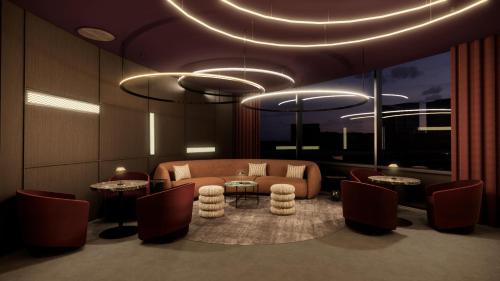 a living room with a couch and a table and chairs at Radisson RED London Twickenham in Twickenham