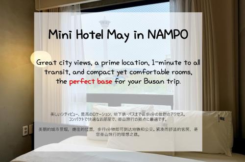a window with a sign that saysmt hotel may in korea at Mini Hotel May Nampo in Busan