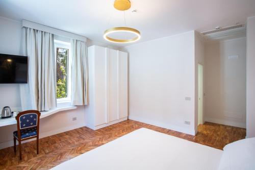 Кровать или кровати в номере Villa Maria Teresa Boutique Hotel
