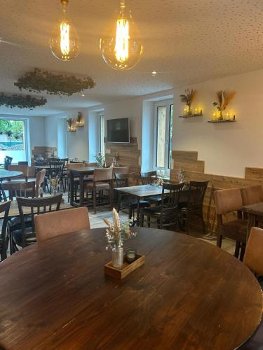 a dining room with tables and chairs and lights at Guesthouse Meitschi Thun - contactless self check-in in Thun