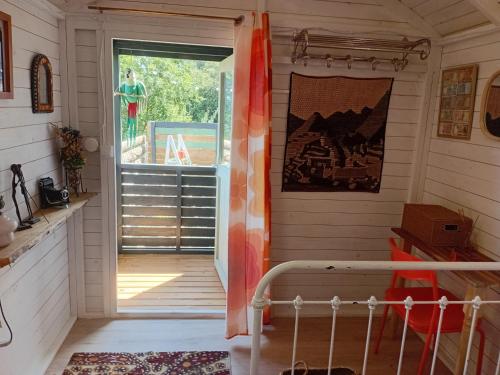 a room with a door leading to a porch at Roulotte Lialou in Saint-Péray