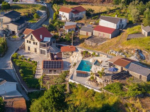 an aerial view of a house with a swimming pool at Casa Pinto Oliveira in Bodiosa