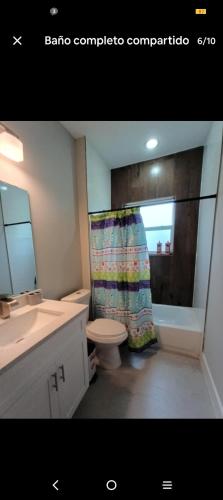a bathroom with a toilet and a shower curtain at Beautiful house in quiet place shared bath in Ocala