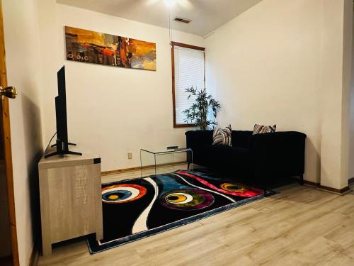 a living room with a couch and a rug with records on it at Greater Grand Crossing/Hyde Park in Chicago