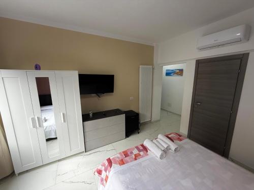 a bedroom with a bed and a flat screen tv at Desire guest House in Pisa