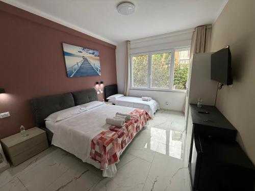 a bedroom with a large bed and a television at Desire guest House in Pisa