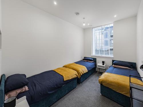 a bedroom with two beds and a window at Stylish 1B Apt in Essex w Modern Touch in Chelmsford