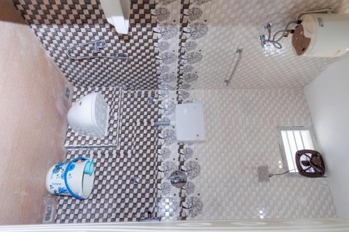 a bathroom with a shower and a toilet at Auro Ocean View Residency in Puducherry