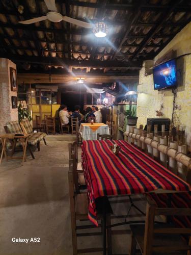 a room with a table with a red blanket on it at La Casa D'Alick in Xochitlán de Romero Rubio