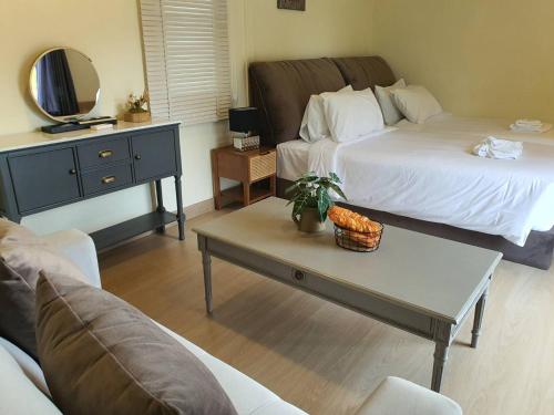 a living room with two beds and a coffee table at Nordika Hill in Pak Chong
