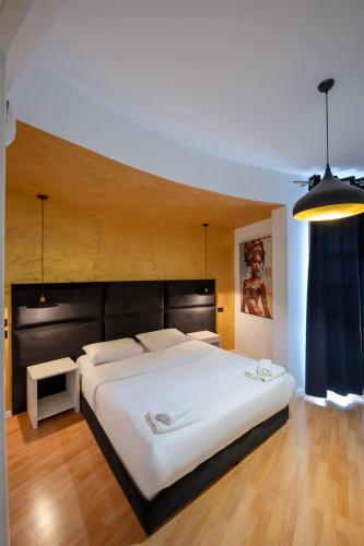 a bedroom with a large white bed in a room at Diamond Central Boutique Hotel in Sarandë