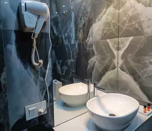 a bathroom with a phone next to a sink at Winners Hill Resorts in Coimbatore