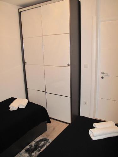 a bedroom with a large closet and a bed at Apartments Mia Krk in Krk