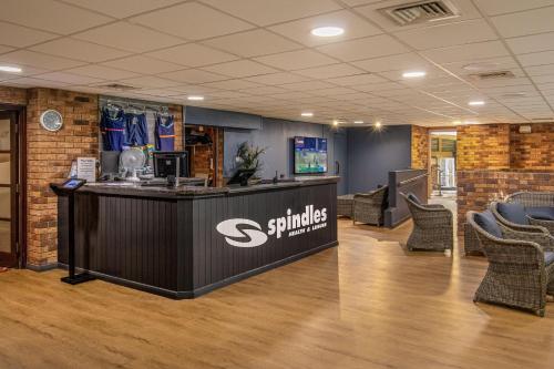 an office lobby with a counter and chairs at Grand Hotel Gosforth Park in Newcastle upon Tyne