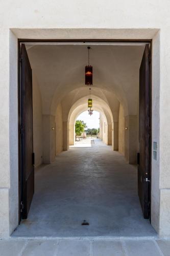 an empty hallway in a building with an archway at Masseria LOGGIA PUCCI in Torre Chianca