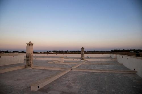 an empty amphitheater with the sunset in the background at Masseria LOGGIA PUCCI in Torre Chianca