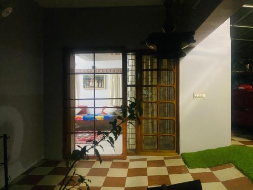a room with a door and a window at Homestay - Heaven Aumgarden in Trivandrum