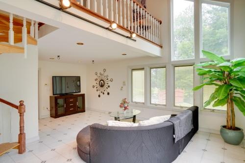 a living room with a couch and a tv at Pool Table and Deck Luxury Mansion in Niskayuna! in Niskayuna