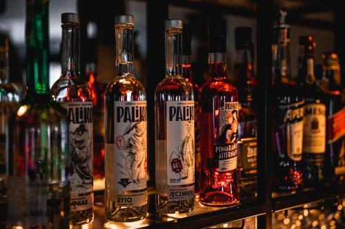 a bunch of bottles of alcohol sitting on a shelf at Gucio - pokoje z restauracją Szczyrk in Szczyrk