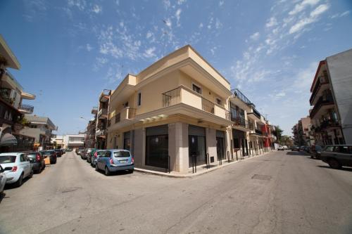 a building on the side of a street with parked cars at Dimora del Balì in Capurso
