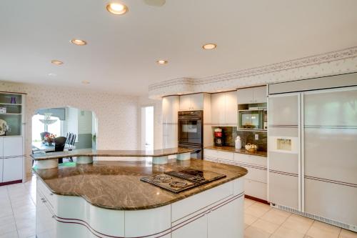 a large kitchen with white cabinets and a large island at Pool Table and Deck Luxury Mansion in Niskayuna! in Niskayuna