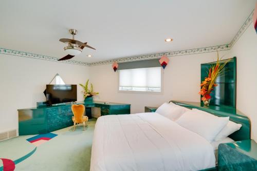 a bedroom with a bed and a desk and a television at Pool Table and Deck Luxury Mansion in Niskayuna! in Niskayuna