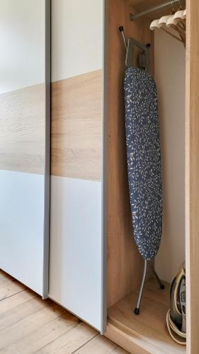 ajar door of a closet with a blue and white door at Apartament Za Murami Gliwice in Gliwice