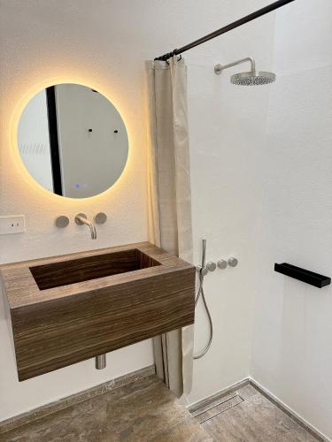 a bathroom with a sink and a mirror at Masseria LOGGIA PUCCI in Torre Chianca