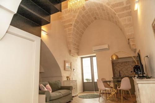 a living room with a couch and a table at La Suite del Faso in Fasano