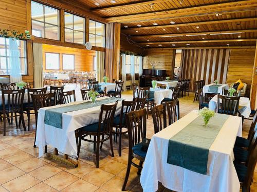 a dining room with tables and chairs in a building at Lakeside hotelli ravintola in Rantasalmi