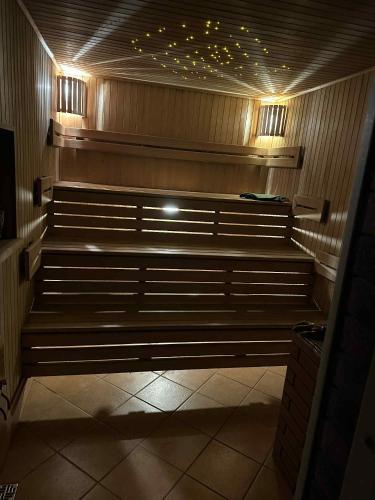 a row of benches in a room with lights at Guest House Vilnius in Vilnius