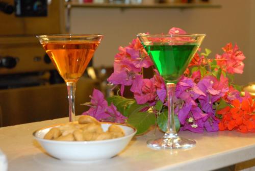 two wine glasses and a bowl of food on a table at Park Hotel Villa Americana in Rodi Garganico