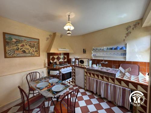 a kitchen with a table and chairs in a room at Ca la rigalla in Amélie-les-Bains-Palalda
