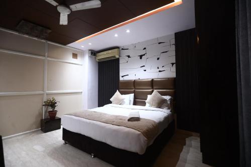 a bedroom with a large bed with birds on the wall at The Bed And Rock Kalkaji in New Delhi