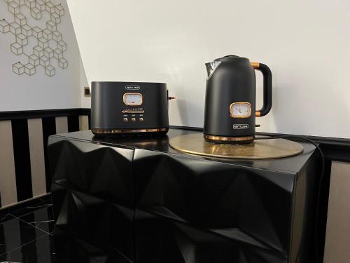 two coffeemakers sitting on a black table at Nero Due in Meckenbeuren