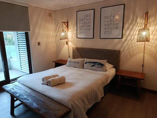 a bedroom with a bed with two towels on it at HOM I Depto Familiar con parking incluido in Puerto Varas