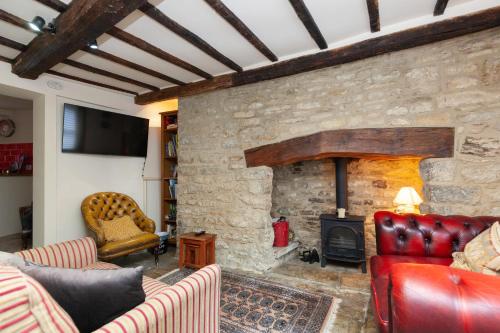 a living room with a stone wall with a fire place at The Crown in Woodstock