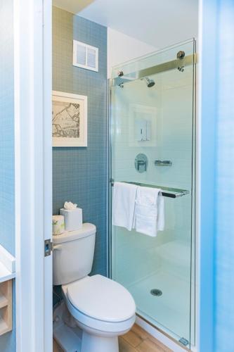 a bathroom with a toilet and a glass shower at The Inn at Longwood Medical in Boston