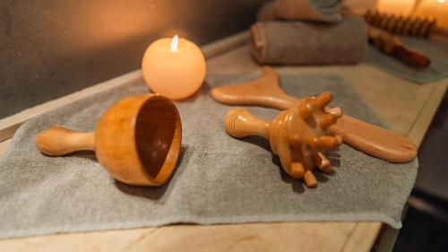 a candle and a wooden toilet on a table at Altafiumara Resort & Spa in Villa San Giovanni